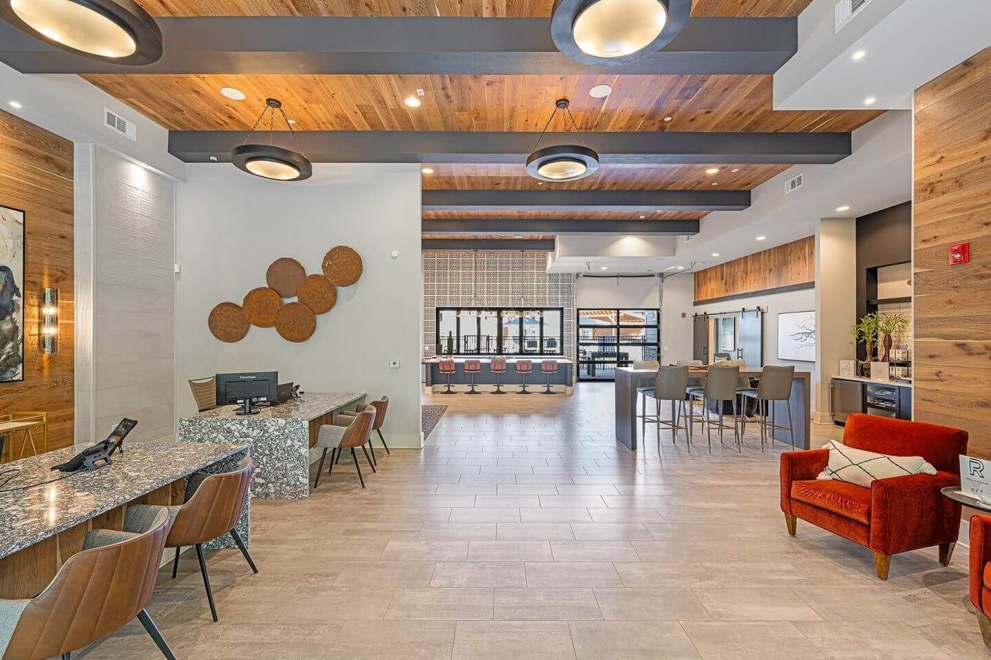 A large room with a lot of furniture and a wooden ceiling