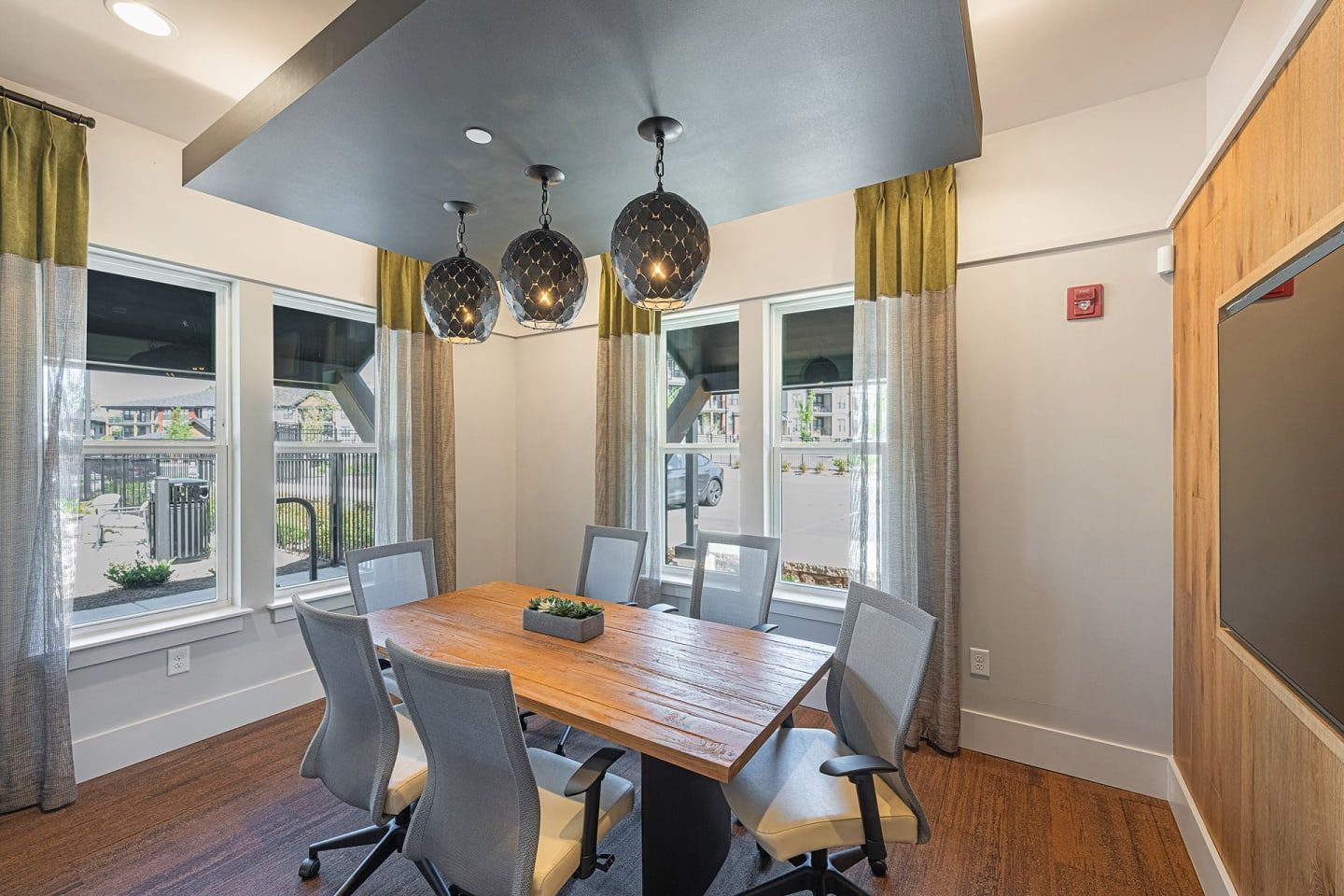 A conference room with a wooden table and chairs
