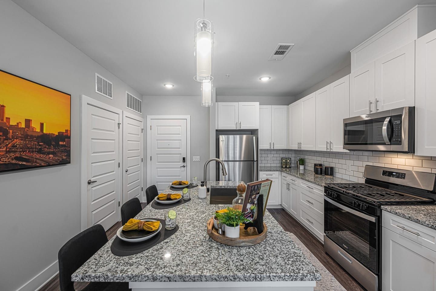 A kitchen with granite counter tops and stainless steel appliances