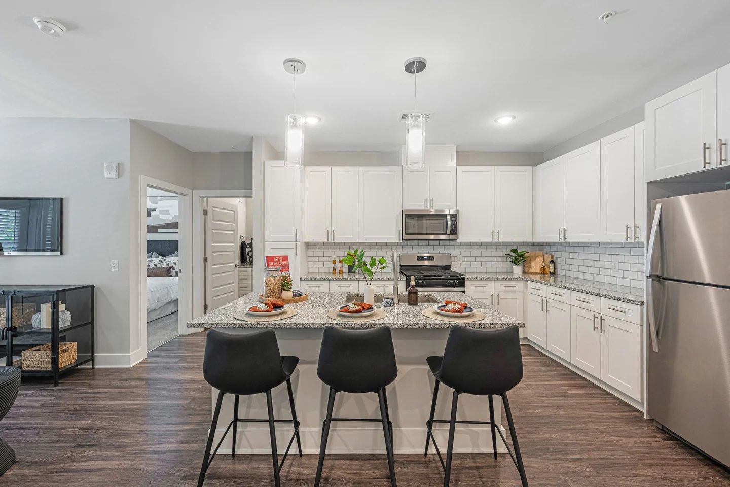 A kitchen with white cabinets and stainless steel appliances