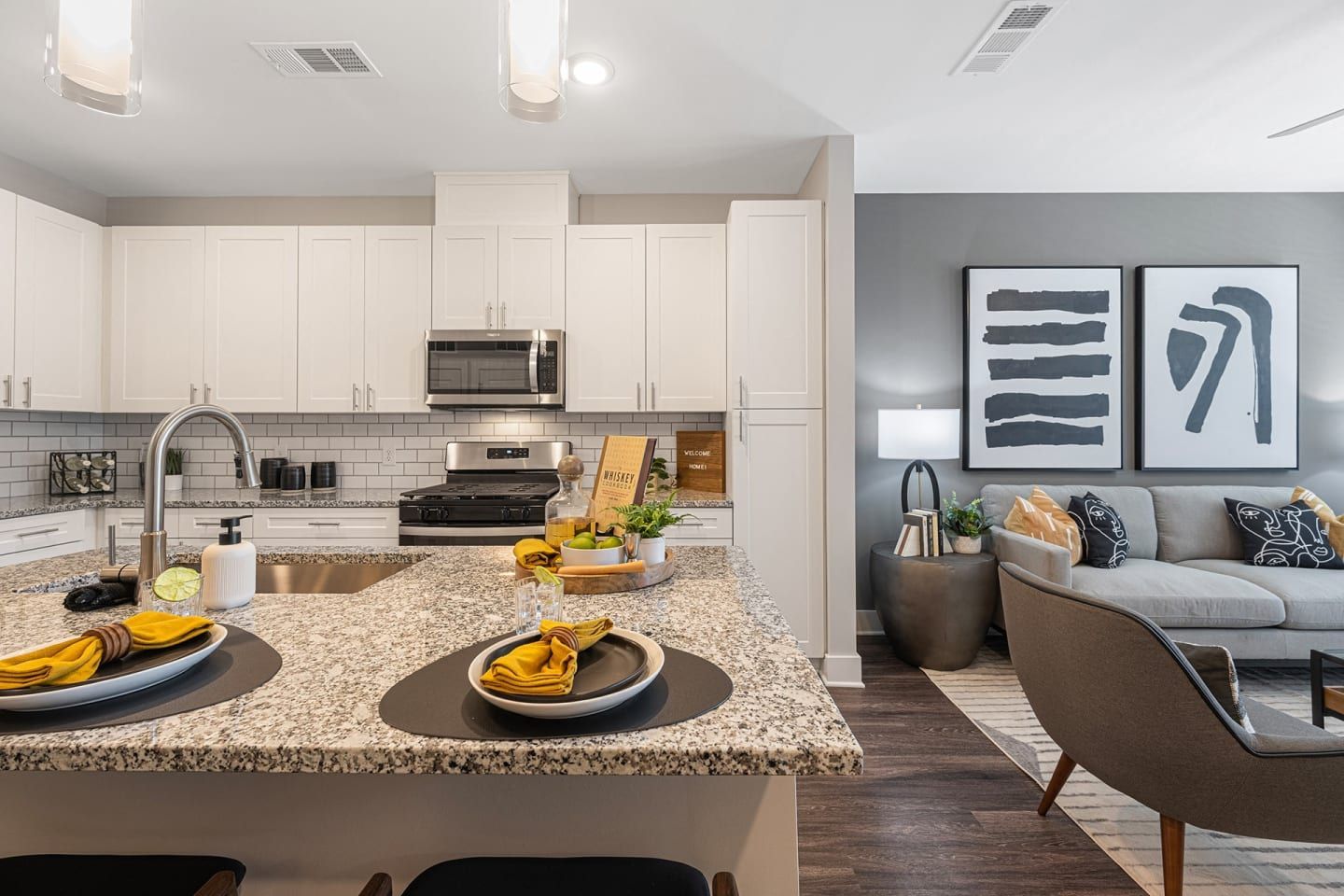 A kitchen with granite counter tops and stainless steel appliances