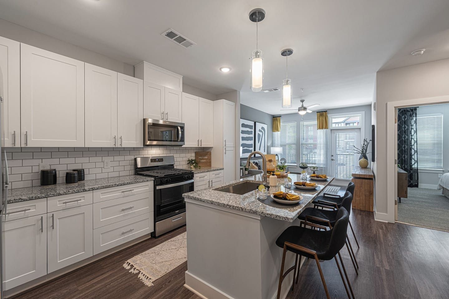 A kitchen with white cabinets and stainless steel appliances