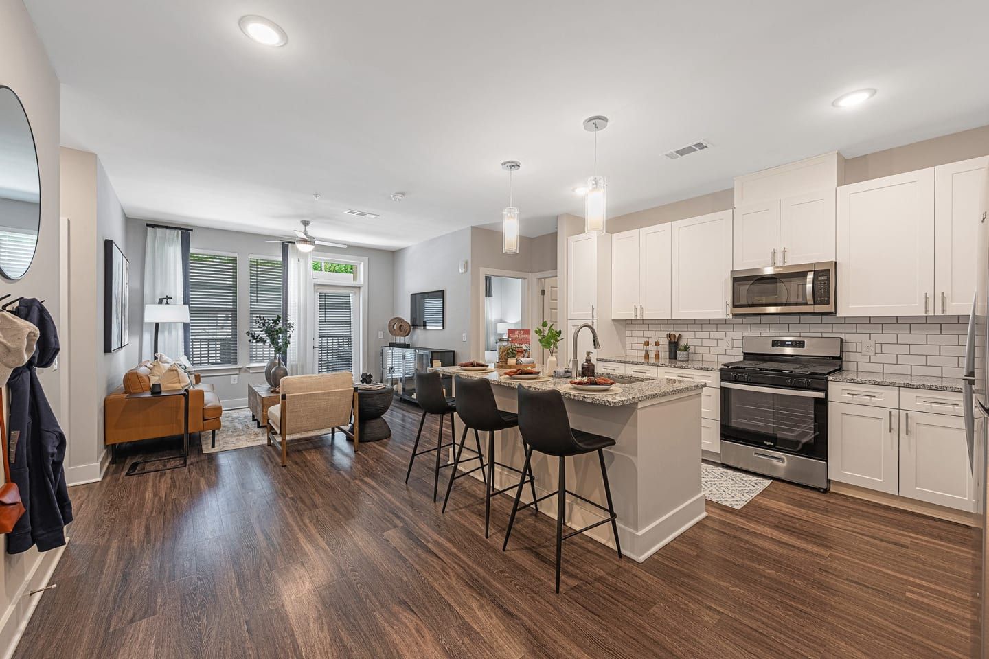 A kitchen with white cabinets and stainless steel appliances