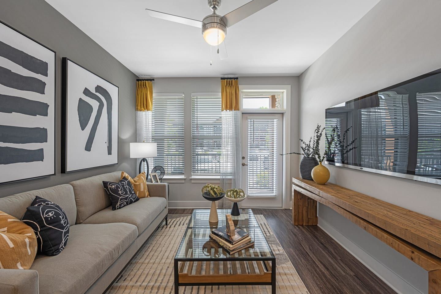 A living room with a couch , coffee table , and television.