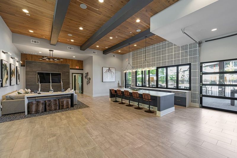 A large room with a lot of windows and a wooden ceiling.