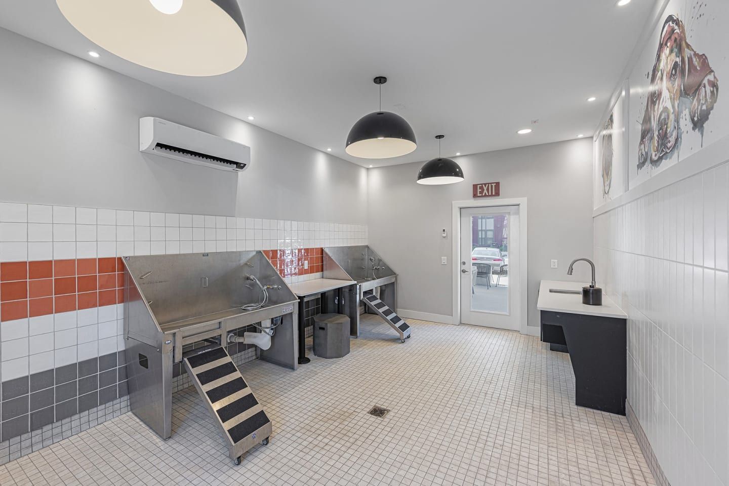 A large room with a lot of stainless steel tables and stairs