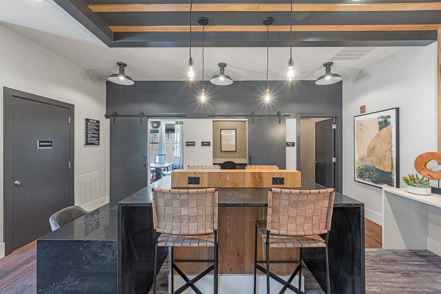 A large room with a table and chairs in it