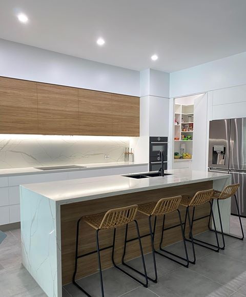 White Kitchen with dim light and wodern cabinetry  in Cairns, QLD