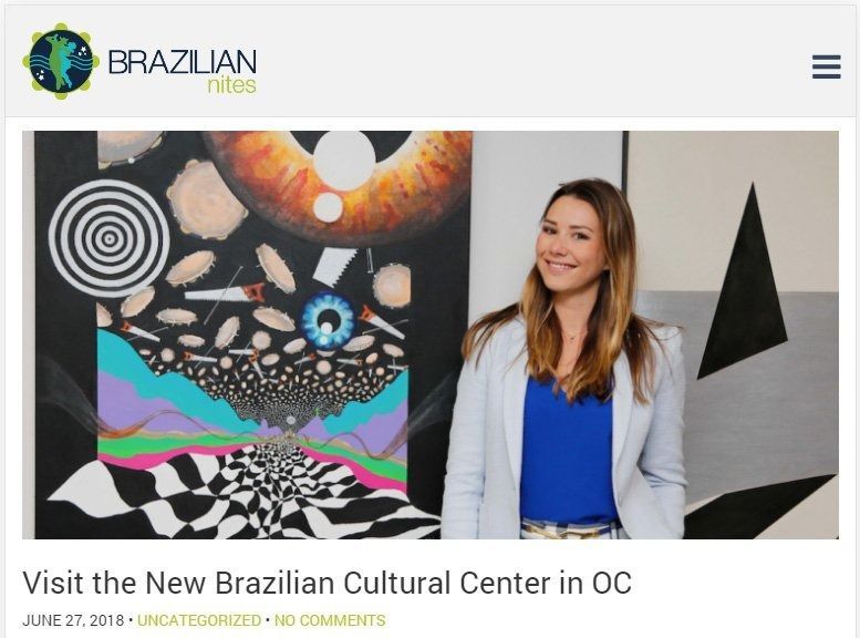 A woman stands in front of abstract art at the Brazilian Cultural Center in Orange County.