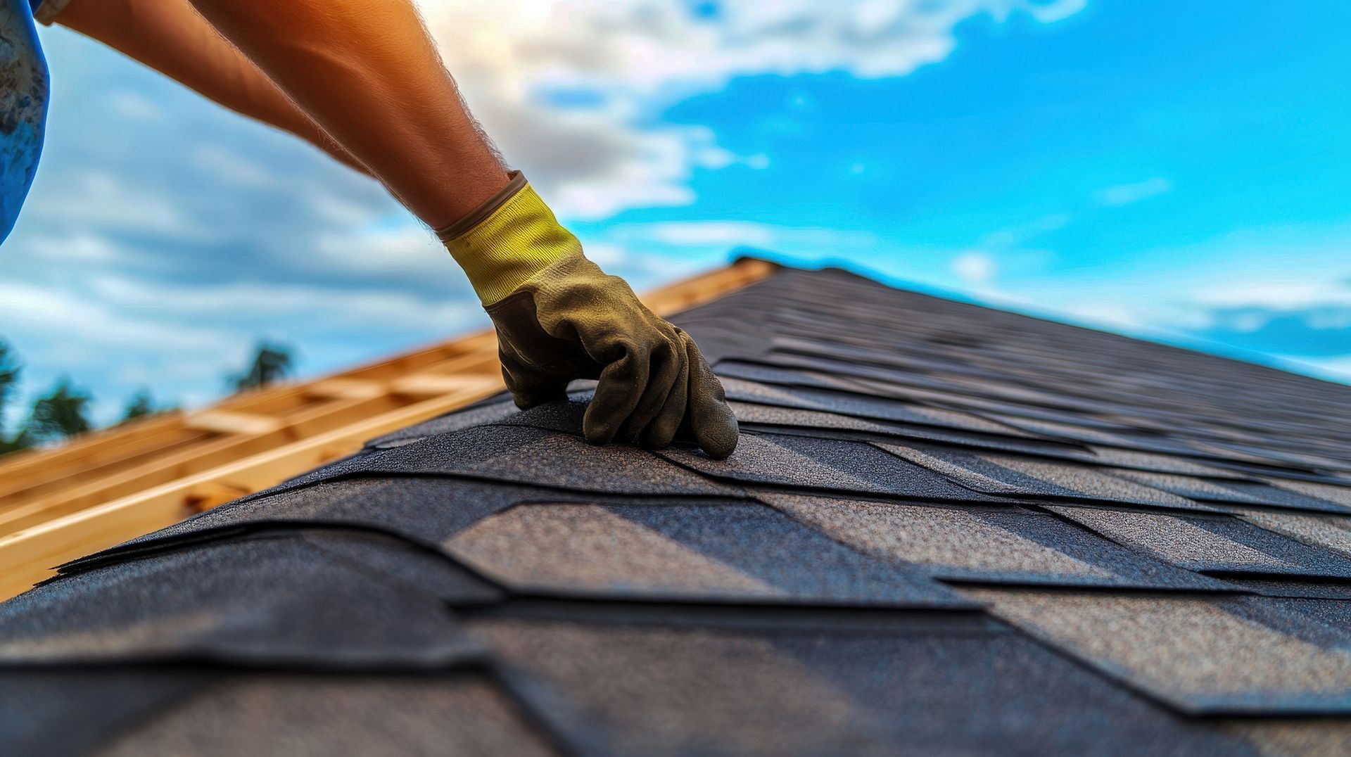 Close-up of expert roofers' hands meticulously laying new shingles during a roof repair. Close-up of expert roofers' hands meticulously laying new shingles during a roof repair.