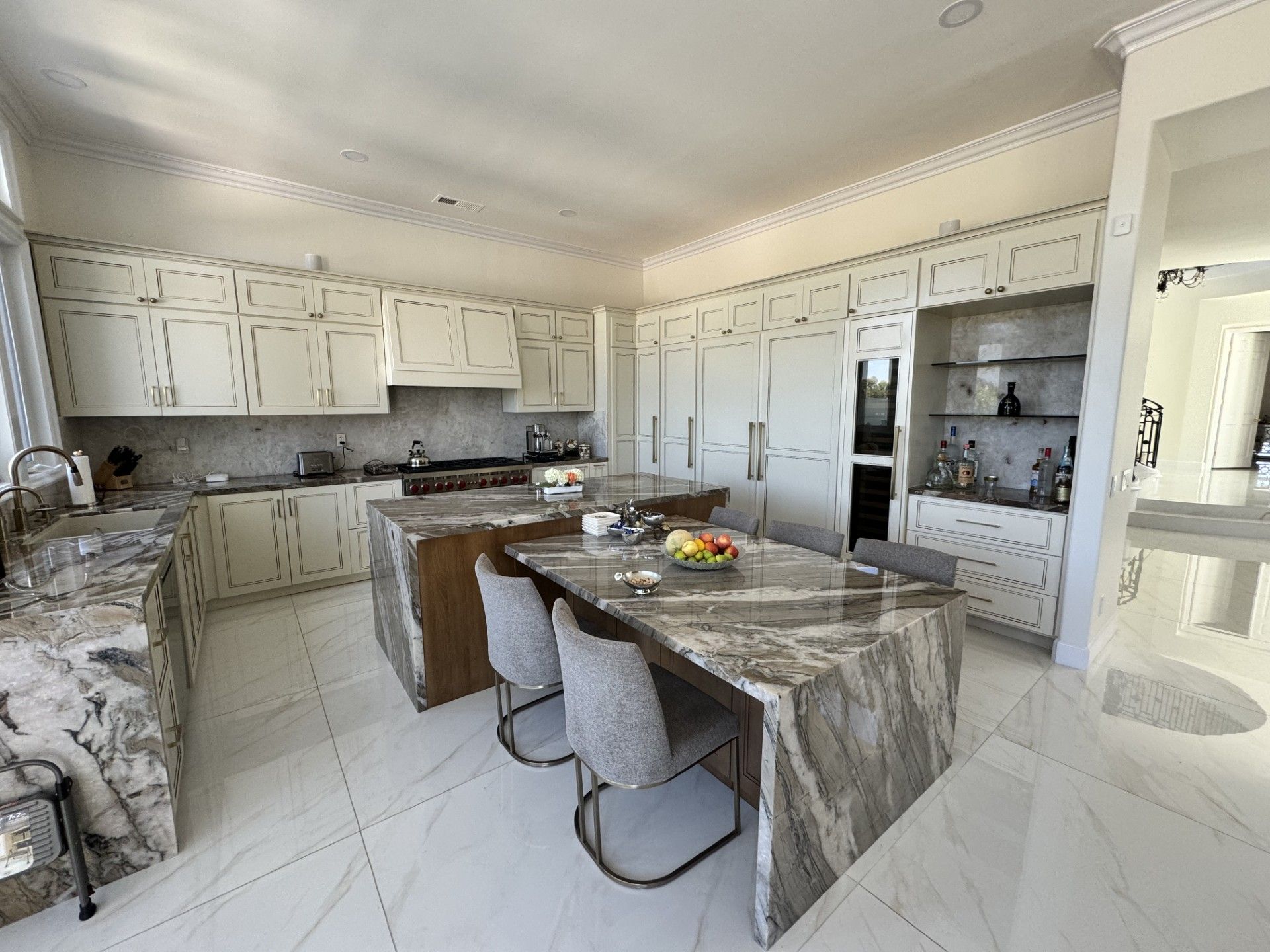 A kitchen with a large island and a table with chairs in it.