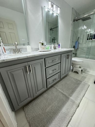 A bathroom with a sink , toilet , and mirror.