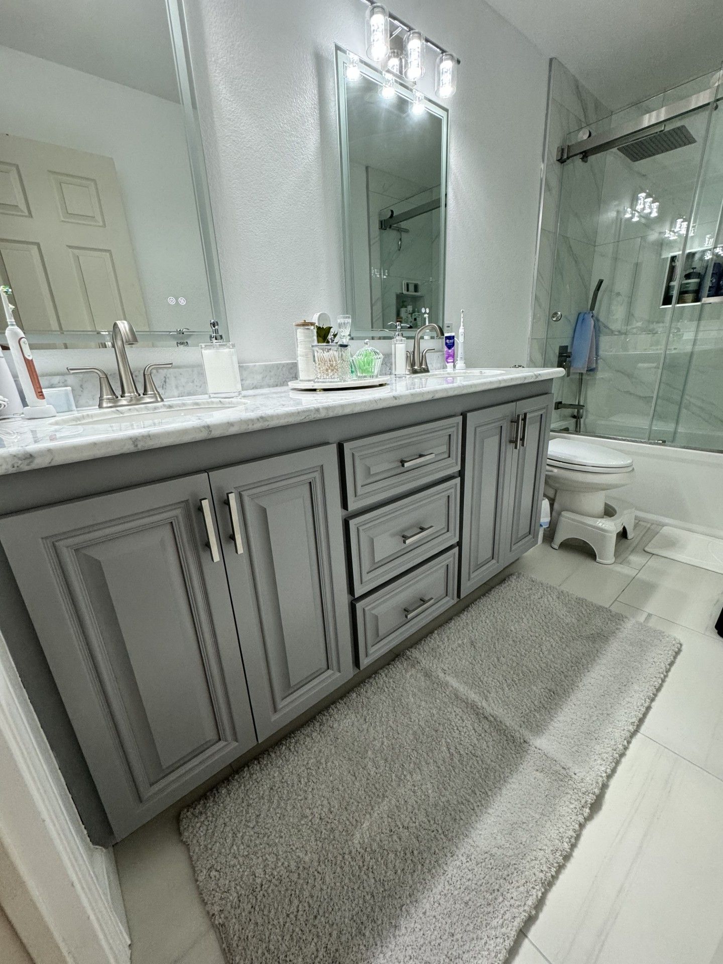 A bathroom with a sink , toilet , and mirror.