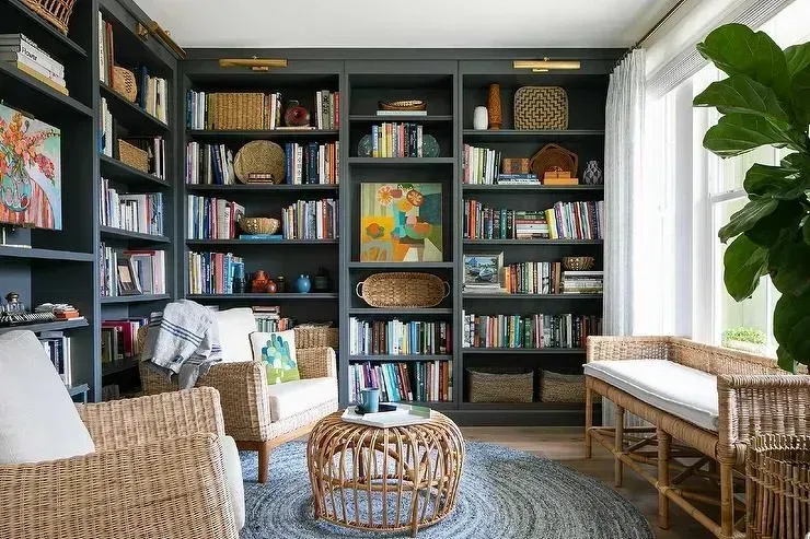A living room filled with furniture and bookshelves.