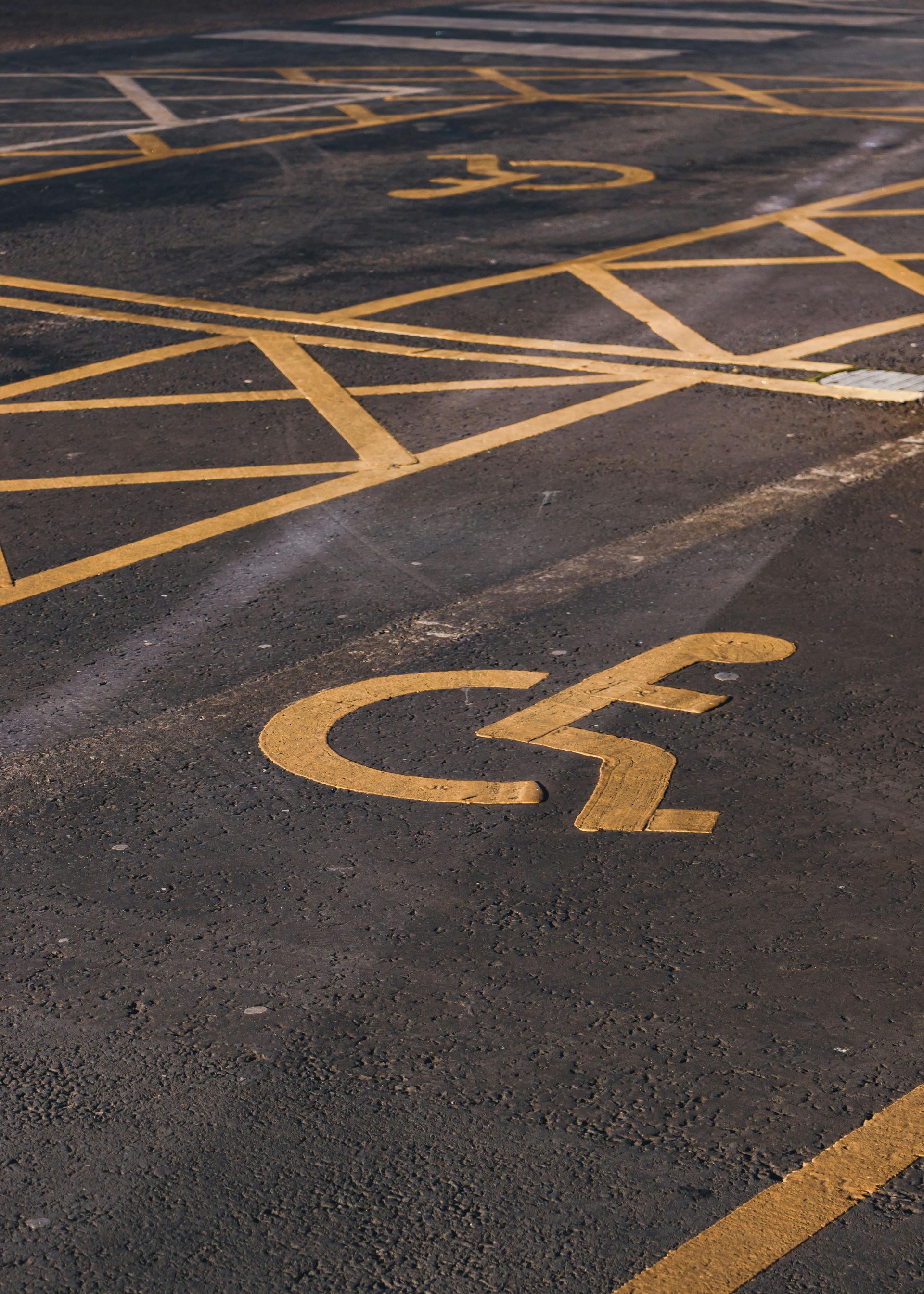 A close up of a parking lot with a handicapped parking spot.