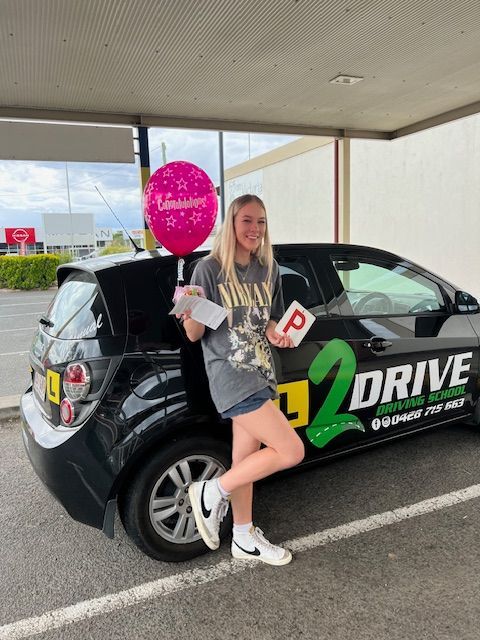 Student proudly showing her P plate — L2Drive Driving School in Warwick, QLD