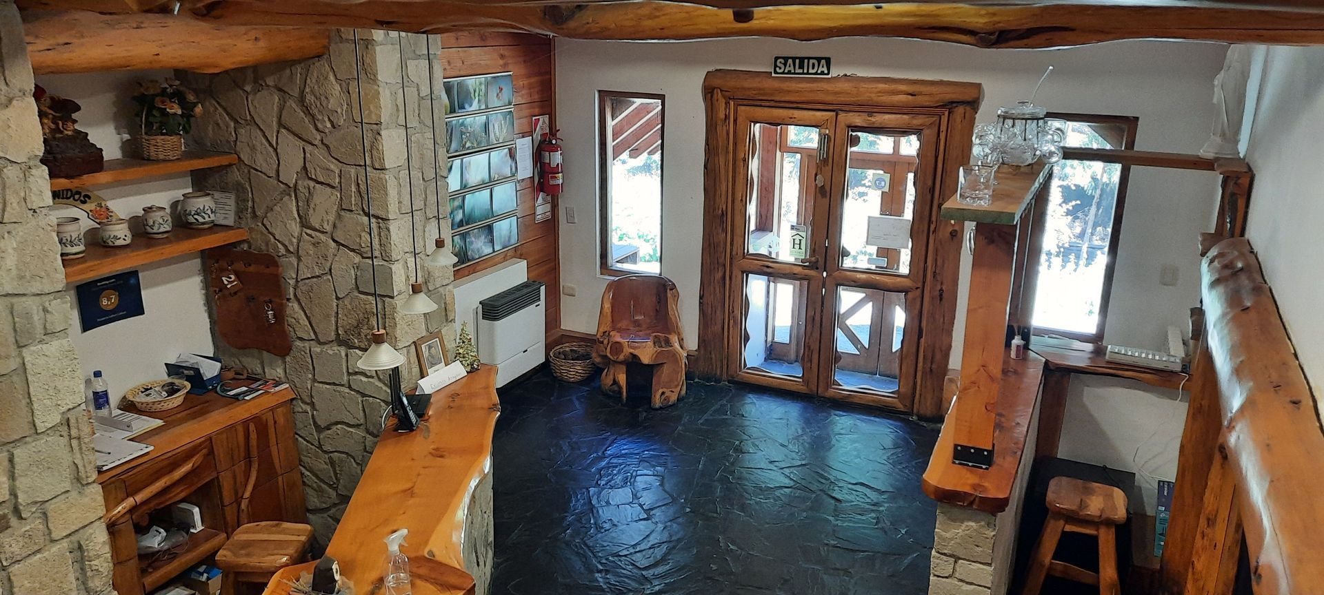 An aerial view of a living room with a fireplace and stools.