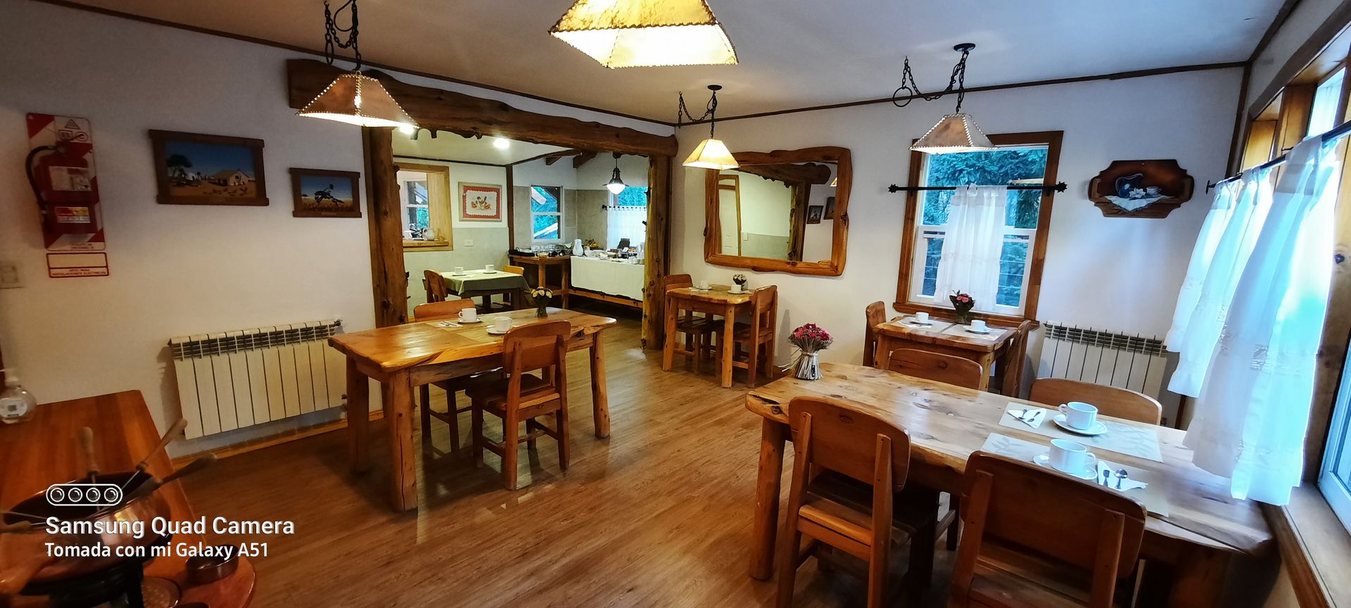 There are many tables and chairs in the room.