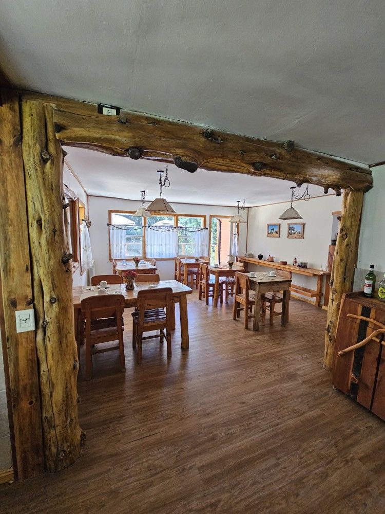 A large dining room with wooden tables and chairs.