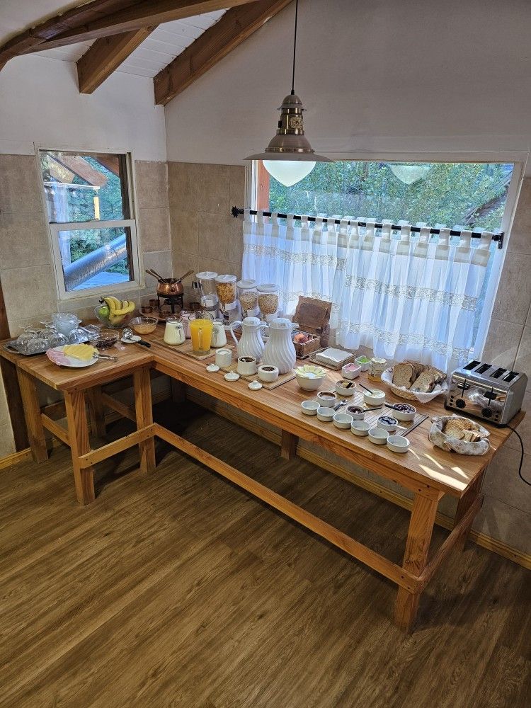 A wooden table with a lot of food on it in a kitchen.