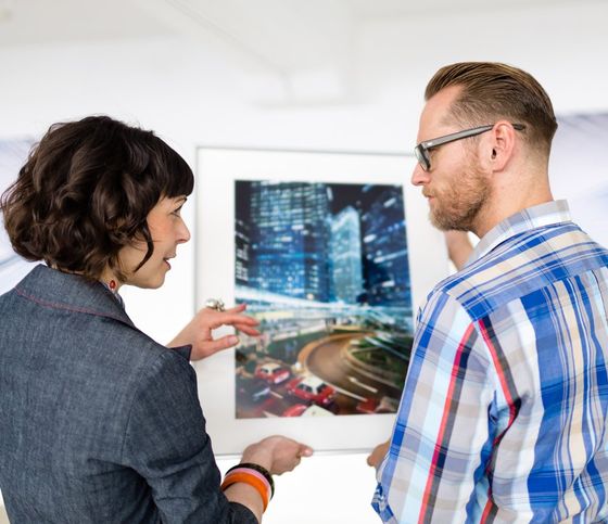 Man Showing His Art Work To A Woman — Minneapolis, MN — Appraisal Specialists Midwest