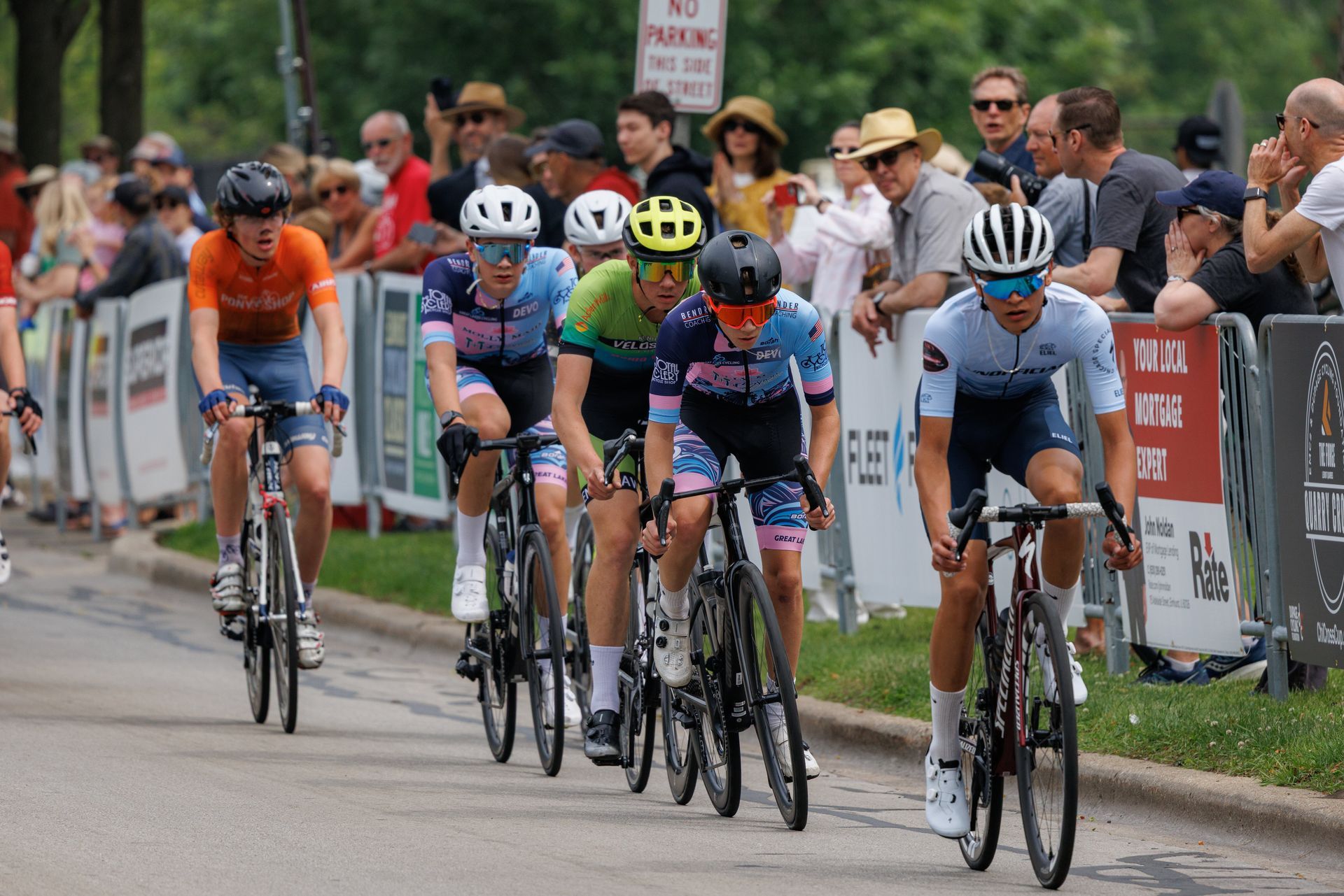 A group of people are riding bicycles down a road.