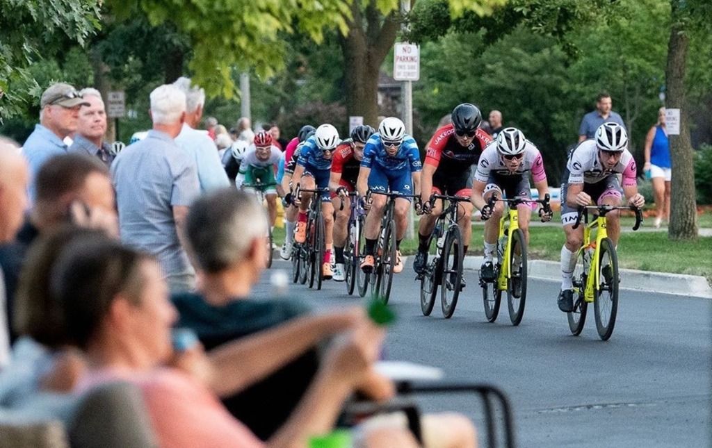 A group of people are riding bicycles down a street.