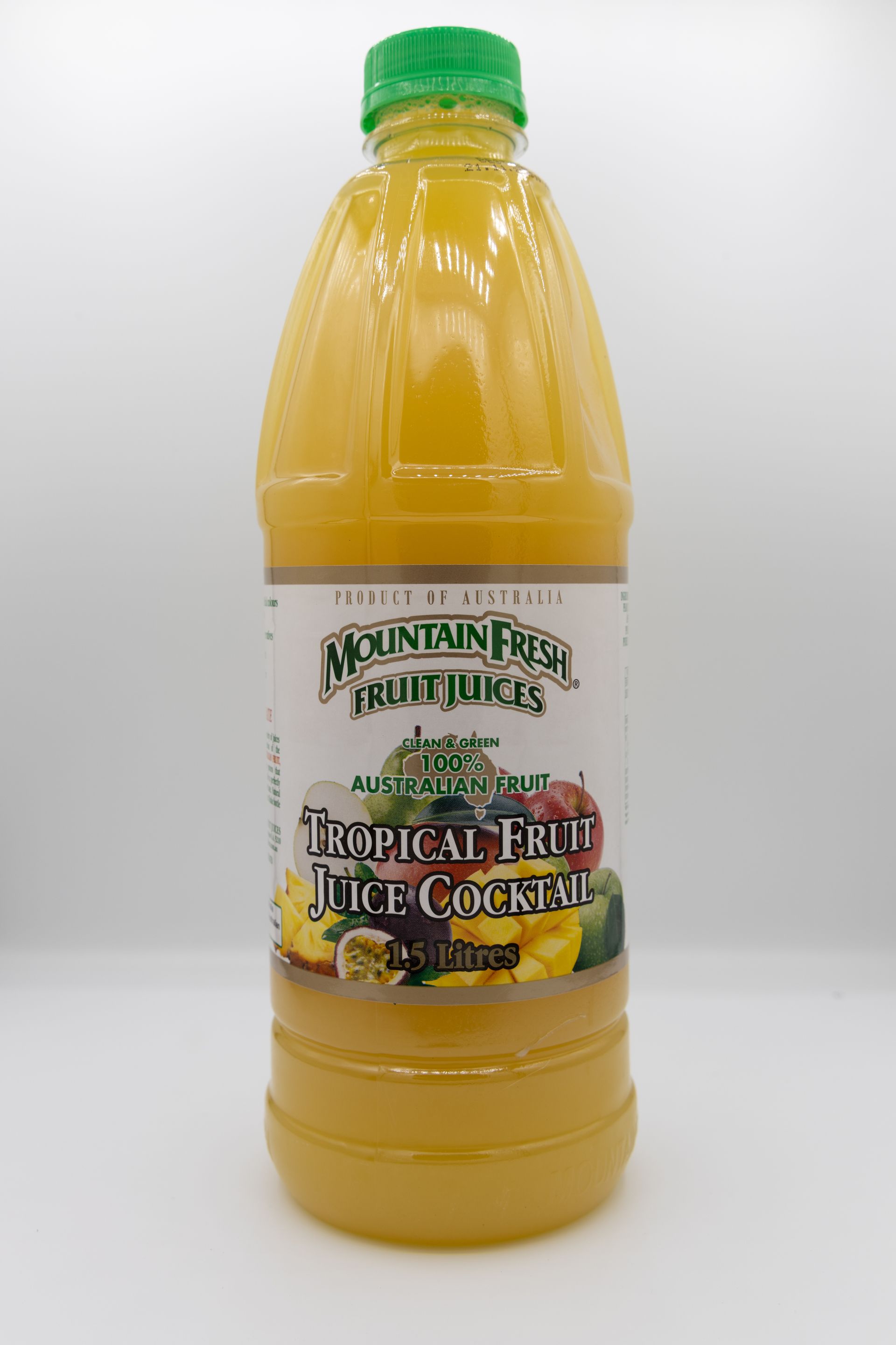 Orange juice bottle with green cap and white label on a plain background