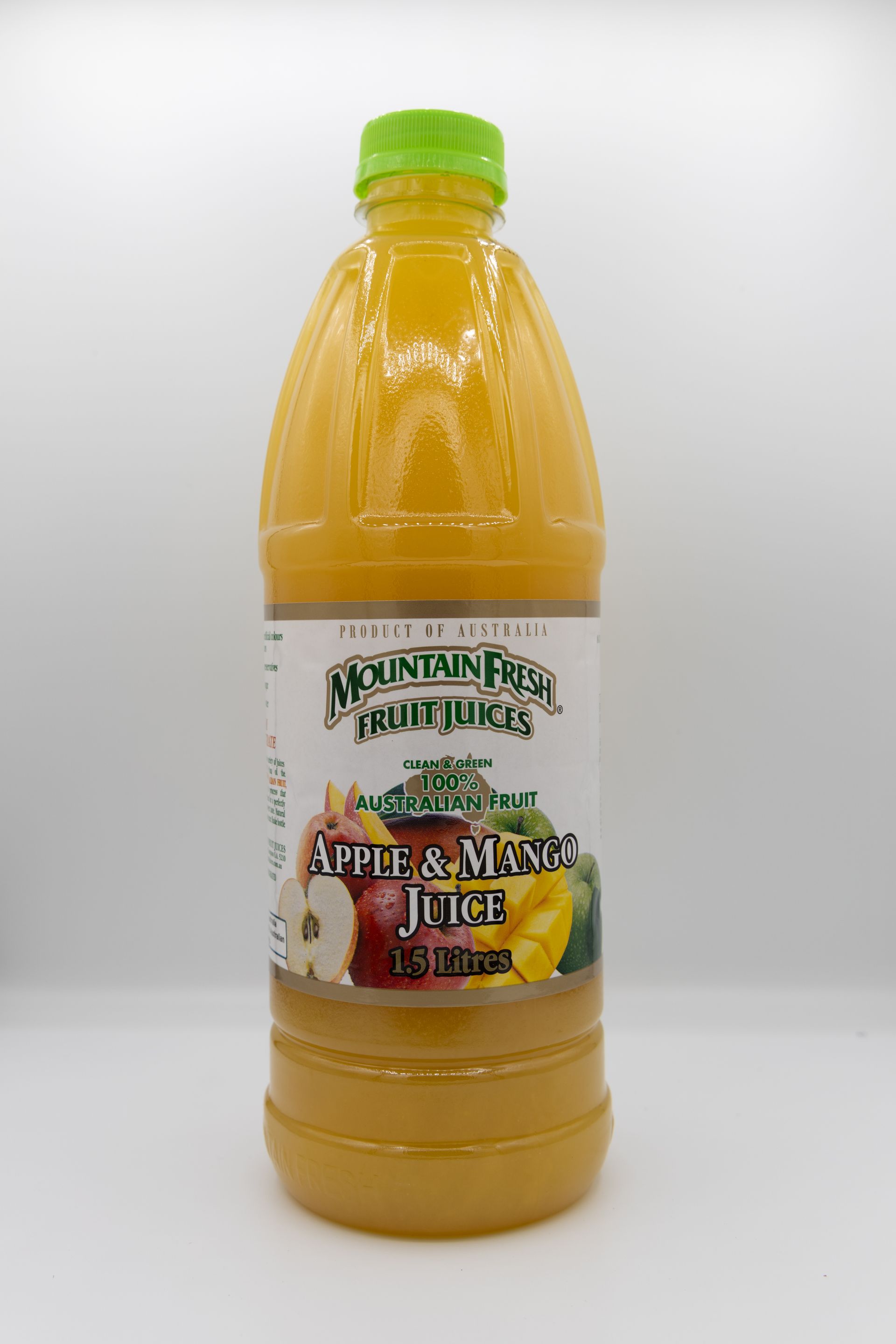 Bottle of apple and mango juice with a green cap and white label on a plain white background