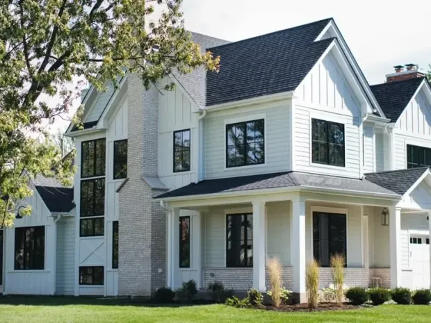 A large white house with white hardie board siding.