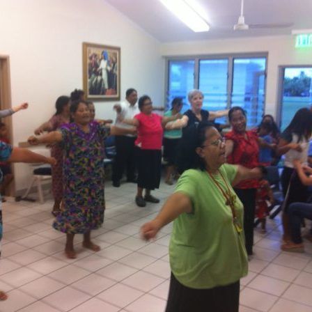 A group of women are dancing together in a room