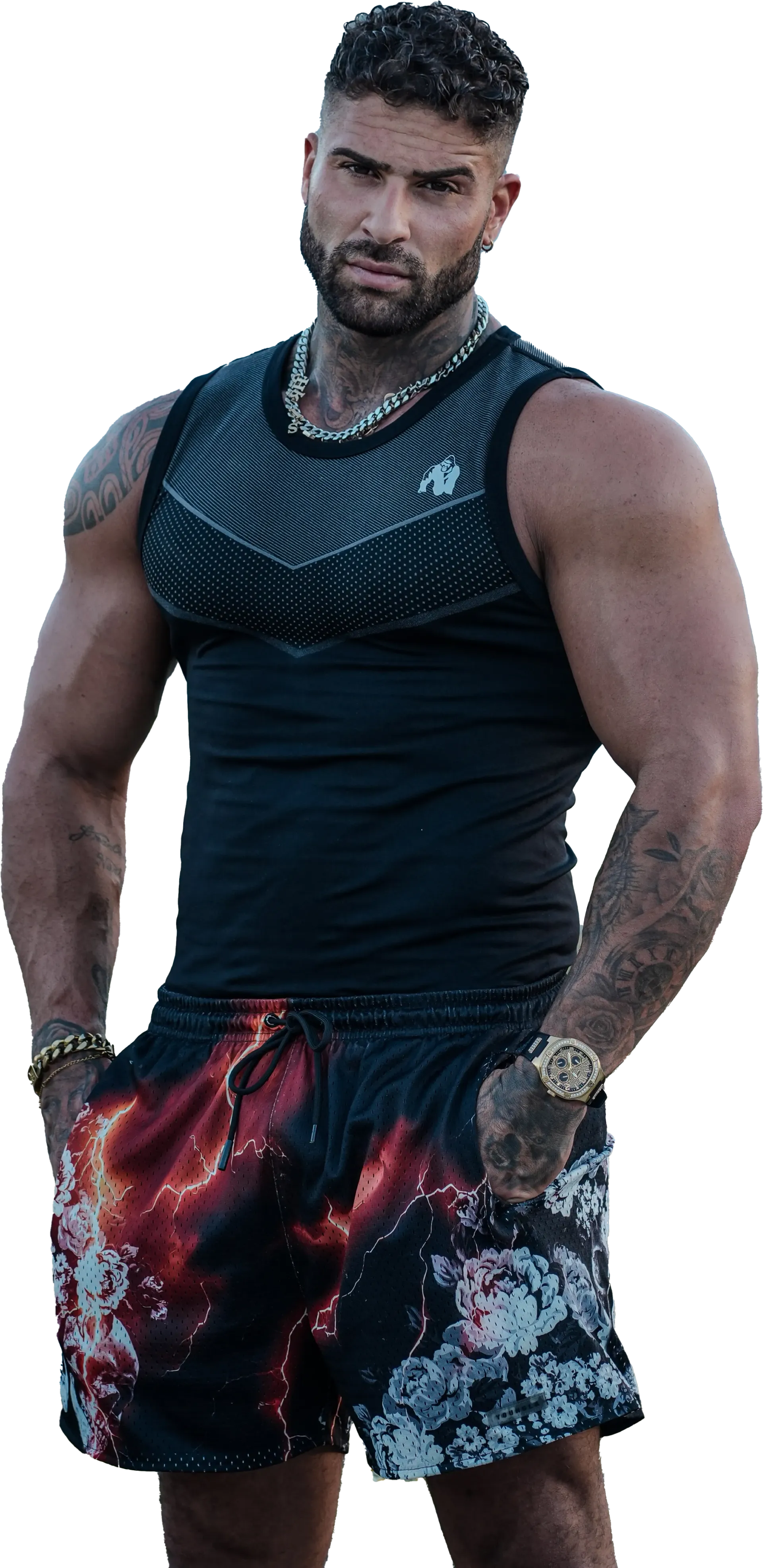 A very muscular man is standing with his hands on his hips.