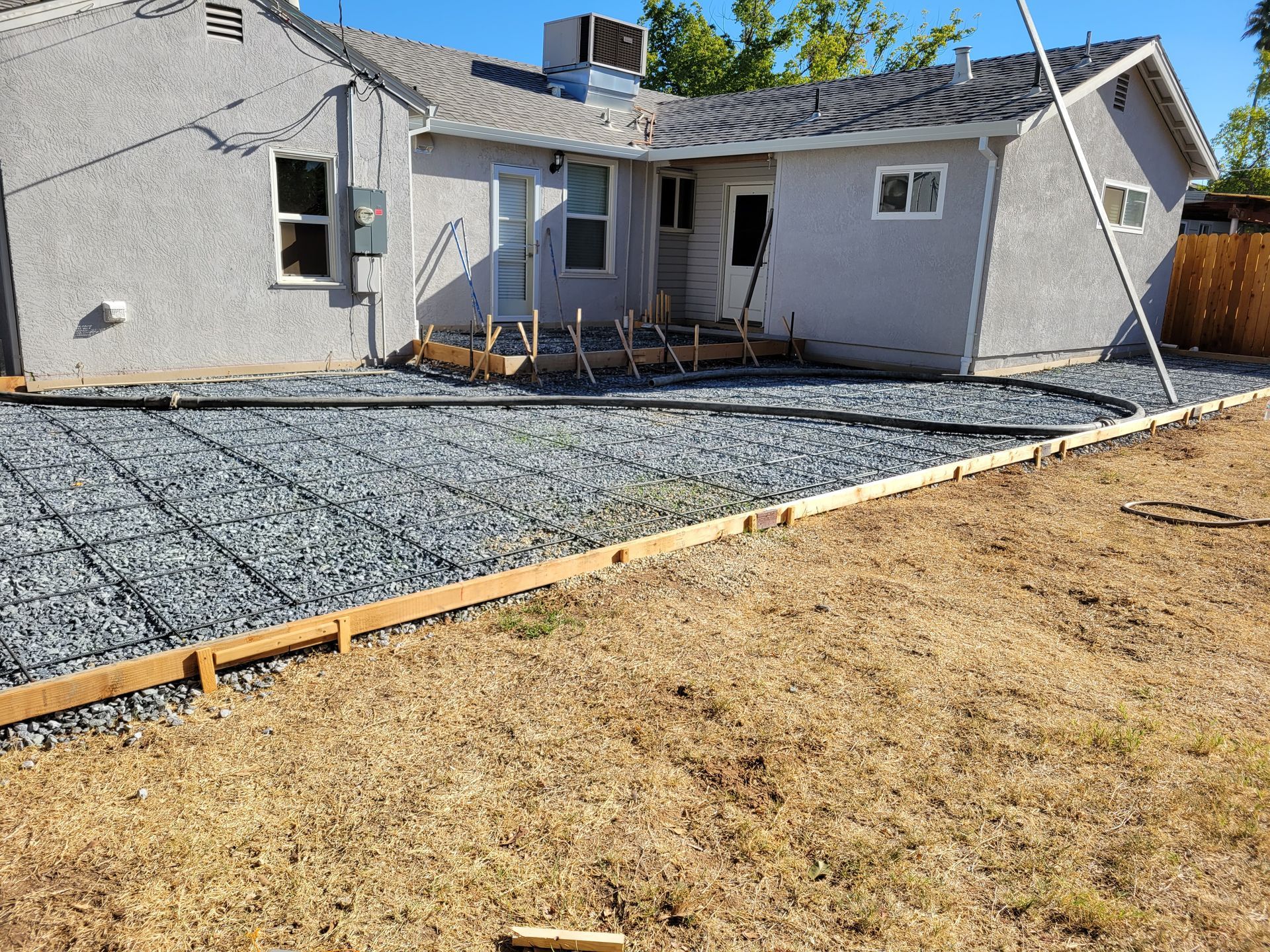 A house with a gravel driveway in front of it.