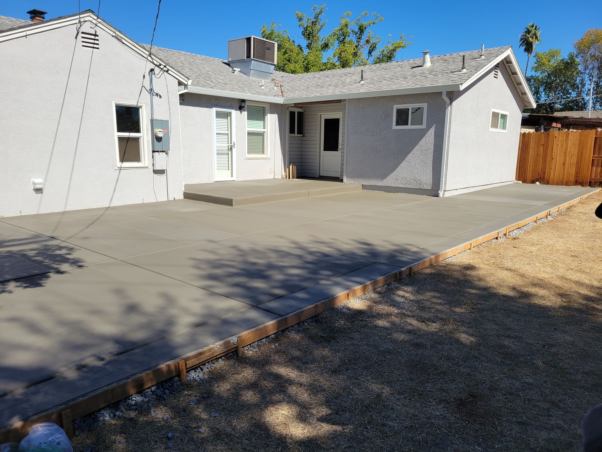 A house with a concrete driveway in front of it.