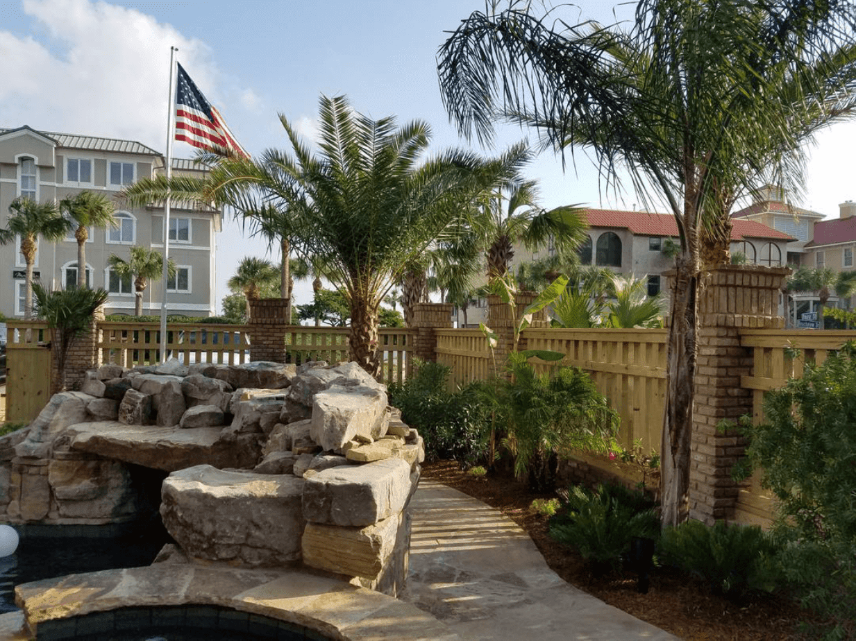 A fountain with an american flag flying in the background