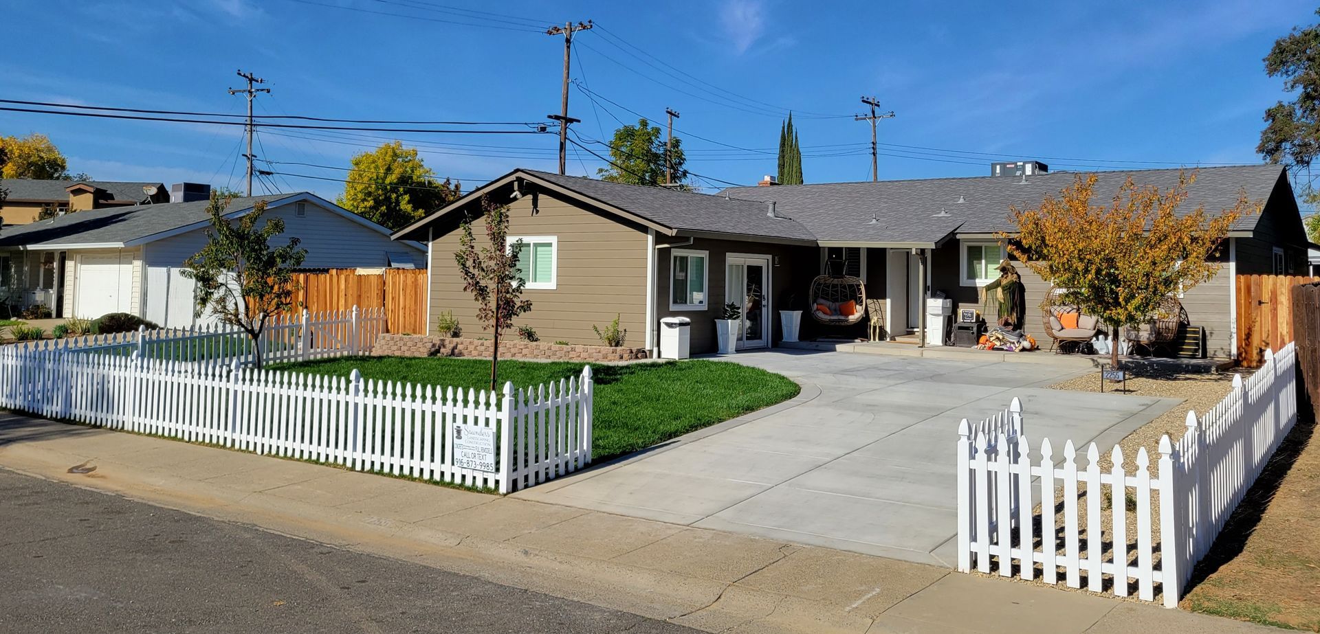 A house with a white picket fence in front of it.