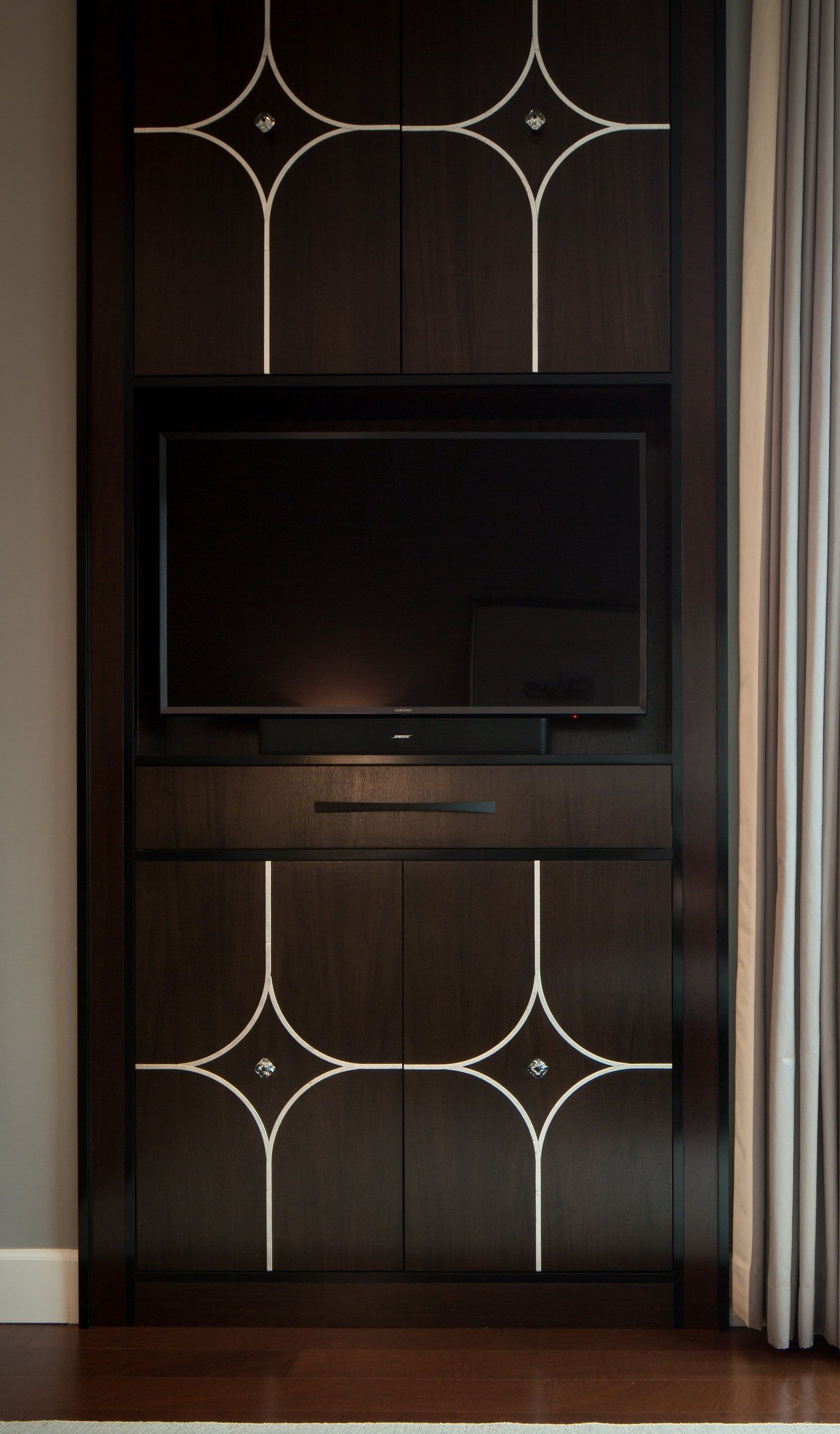 A flat screen tv is mounted on a wooden cabinet