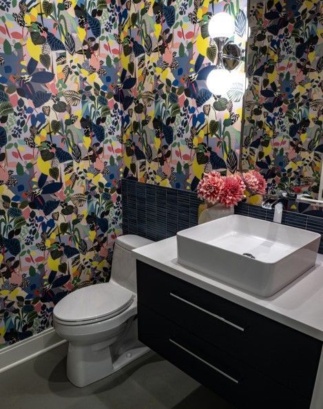 A bathroom with a toilet a sink and a mirror