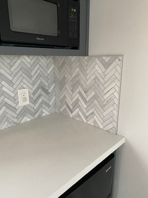A kitchen with a microwave , dishwasher , and counter top.