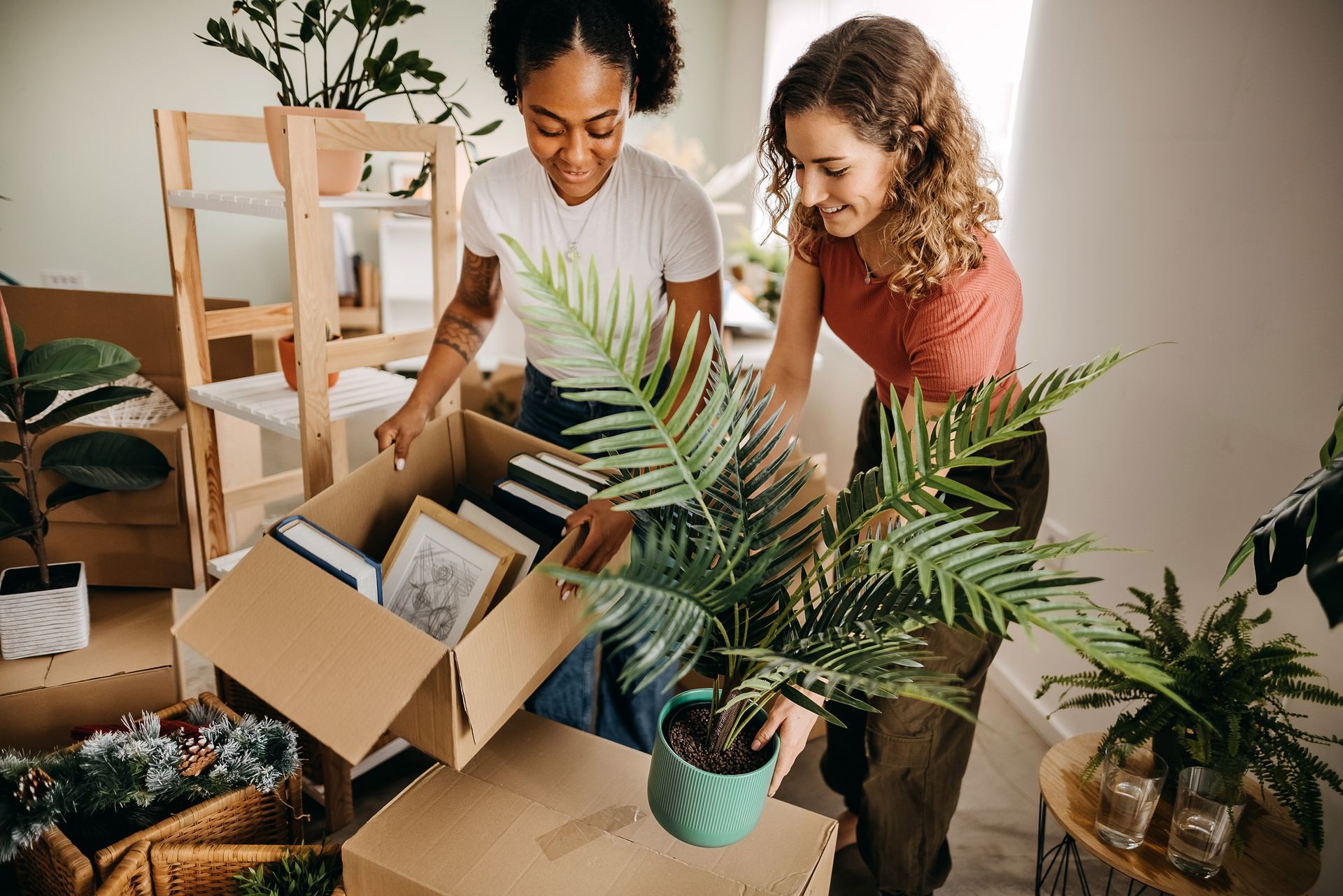 stock photo of friends unpacking boxes