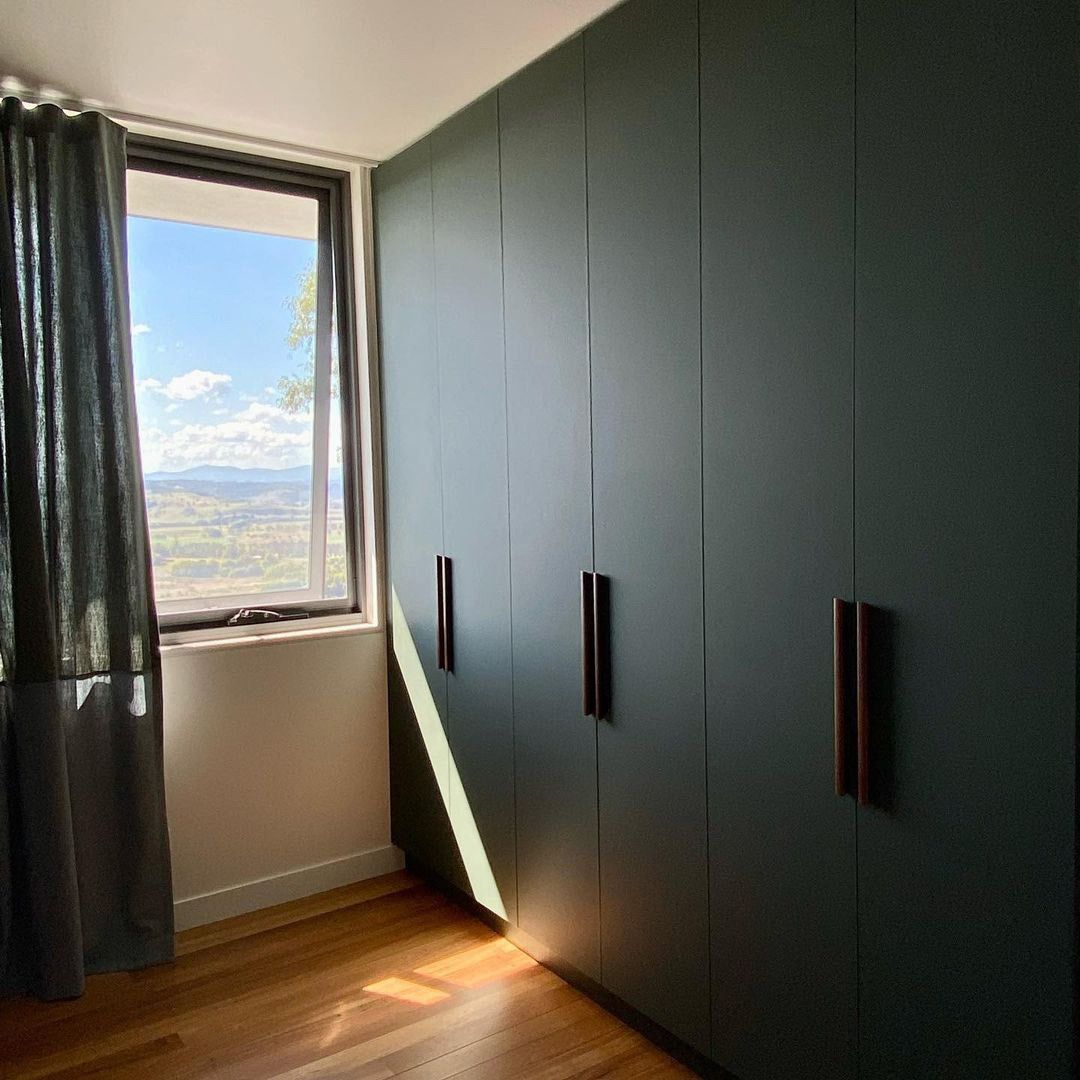 A Bedroom With A Large Window And A Large Wardrobe — Ben Lynch Cabinetmaking in Casino, NSW