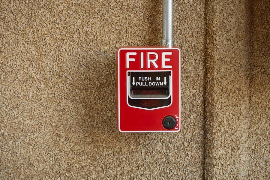 A Red Fire Alarm Is Hanging On A Wall — Firewerx In Dubbo, NSW