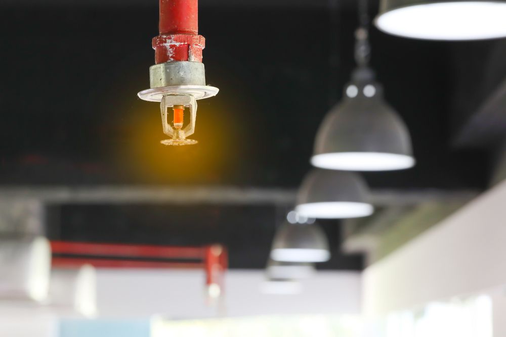 A Fire Sprinkler Is Hanging From The Ceiling Of A Building — Firewerx In Dubbo, NSW