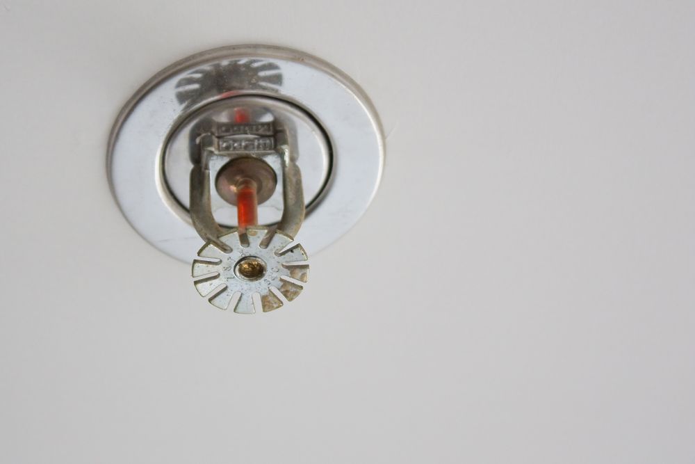 A Fire Sprinkler Is Hanging From The Ceiling On A White Wall — Firewerx In Dubbo, NSW