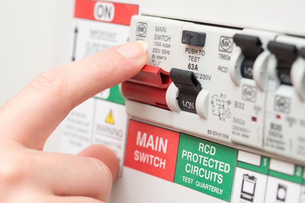 A Person Is Pressing A Red Button On A Main Switch — Firewerx In Dubbo, NSW