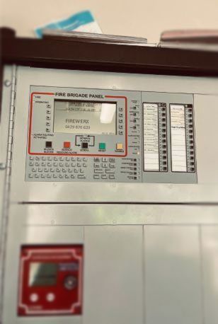 A Fire Alarm Panel Is Hanging On A Wall — Firewerx In Dubbo, NSW
