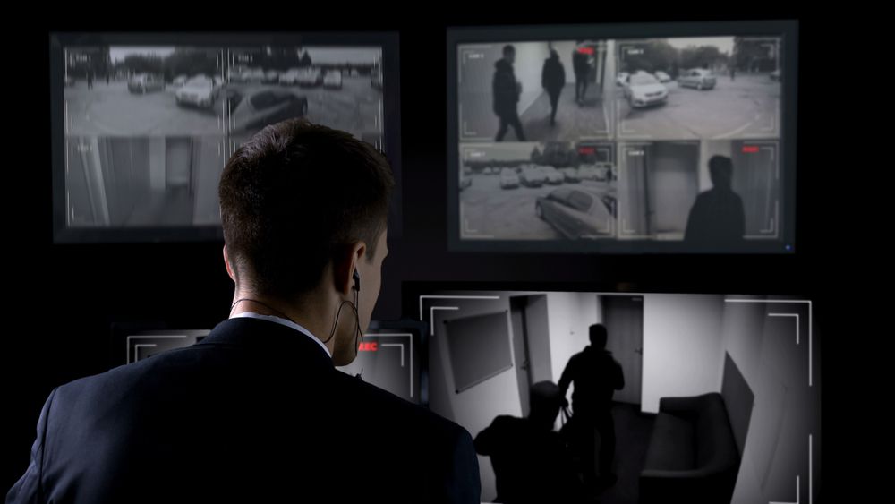 Man Checking Security Camera Footage at Night
