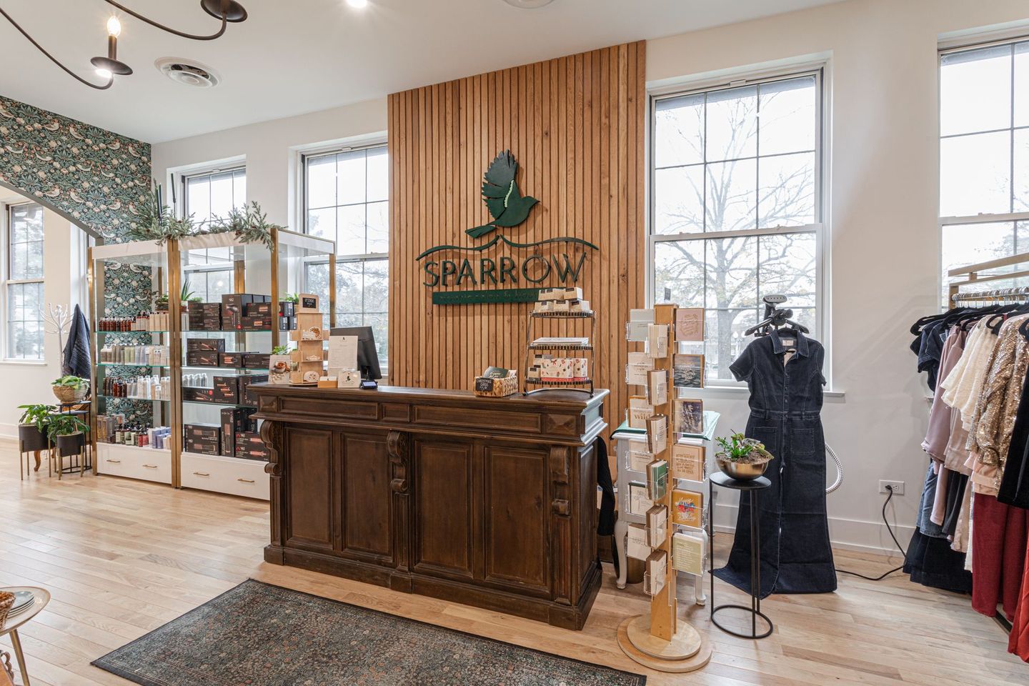 Interior of Sparrow boutique with wooden decor, displays, and clothing racks.