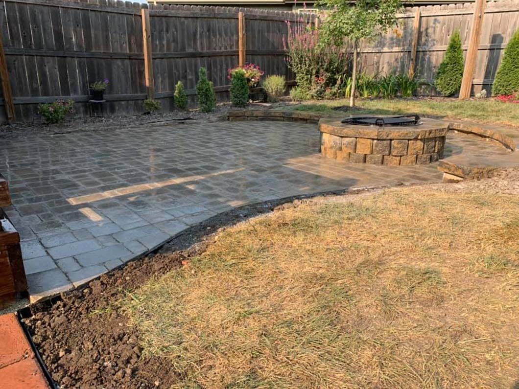There is a fire pit in the middle of the backyard.