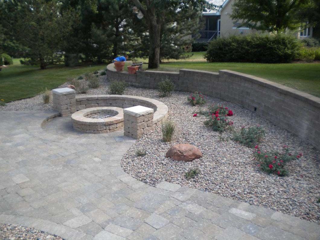 There is a fire pit in the middle of the patio.